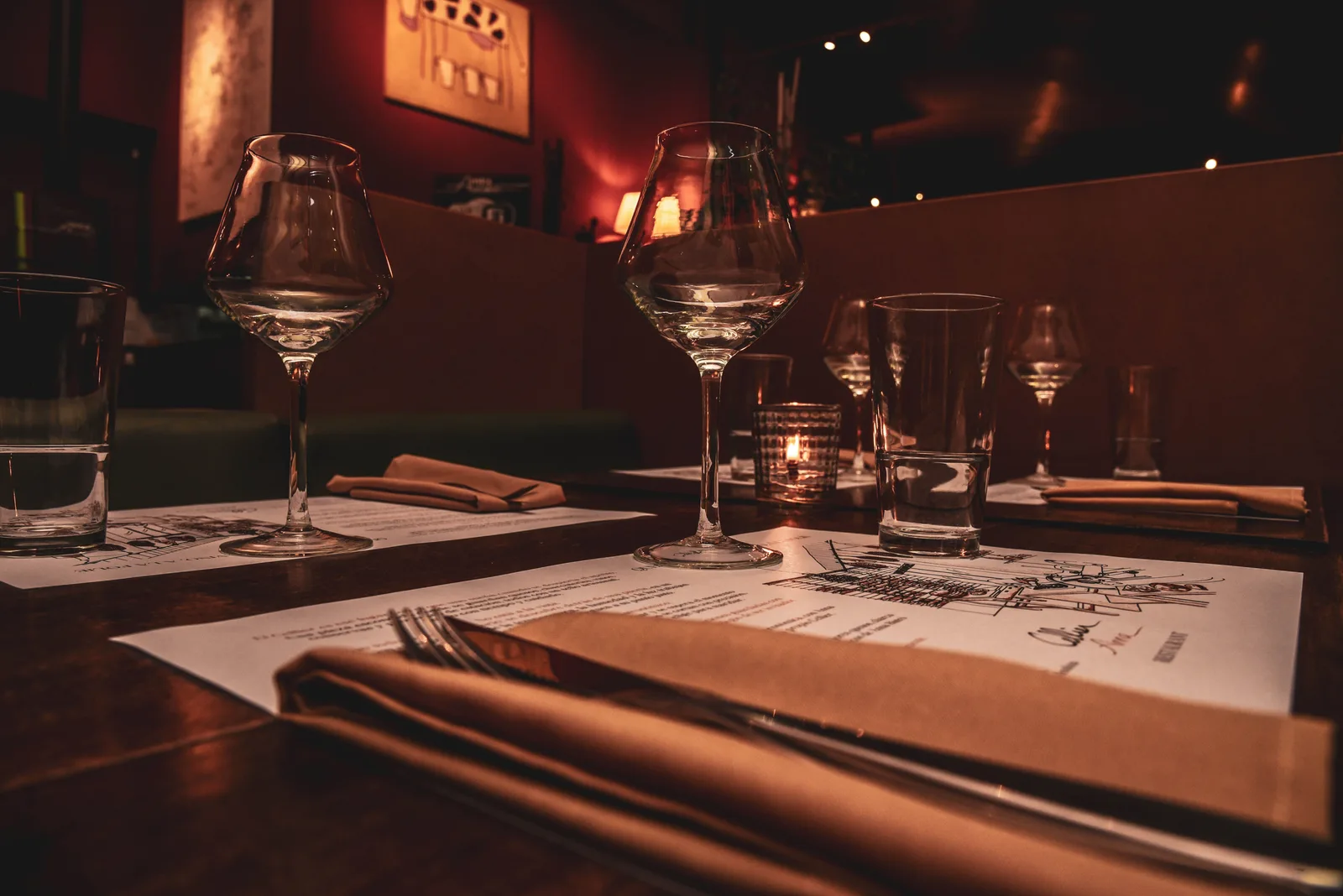 A candlelit table in a dark dining room